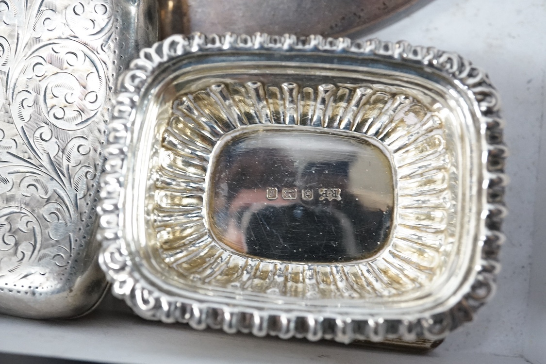 A group of small silver including a George V capstan inkwell, Birmingham, 1924, base diameter 14cm, two cigarette cases, a vesta case, a five bar toast rack, a commemorative dish, mounted glass toilet jar, a matchbook ca